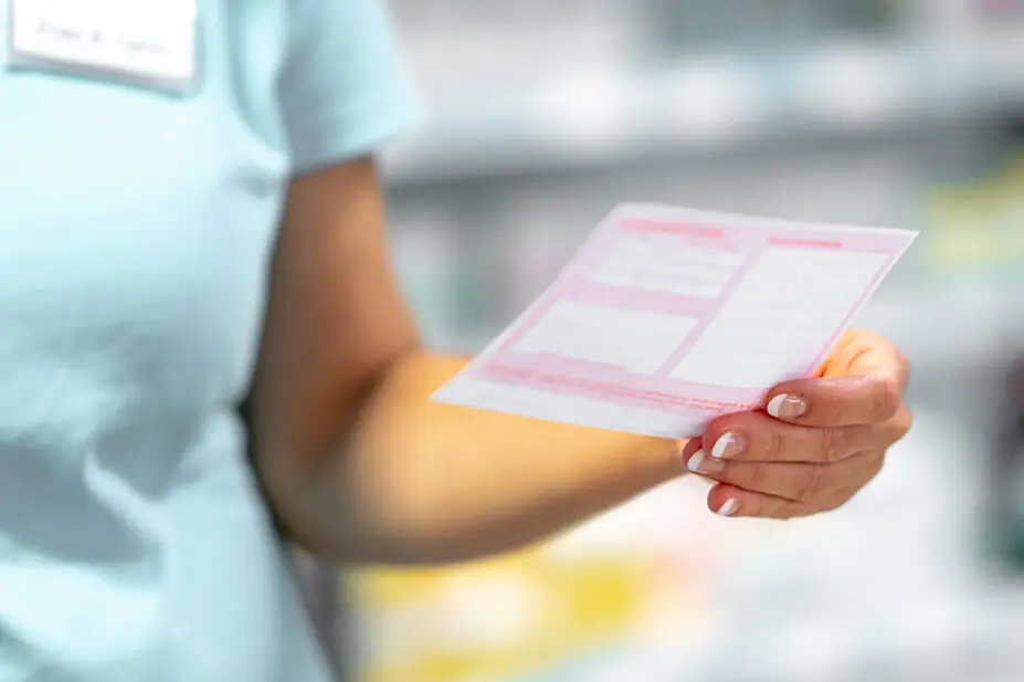 Pharmacist holds a prescription