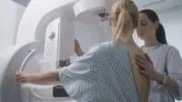 Woman undergoes mammography screening examination