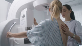 Woman undergoes mammography screening examination