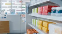 The stocked shelves of a community pharmacy