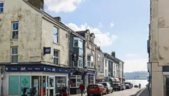 Shops in Cornish town, showing a community pharmacy