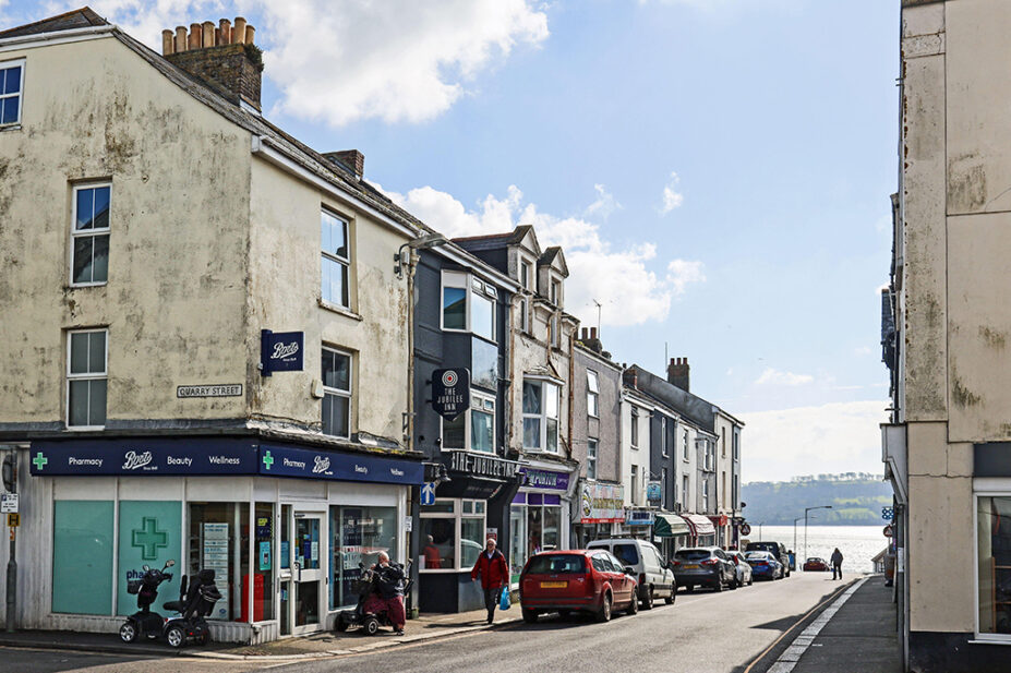 Shops in Cornish town, showing a community pharmacy