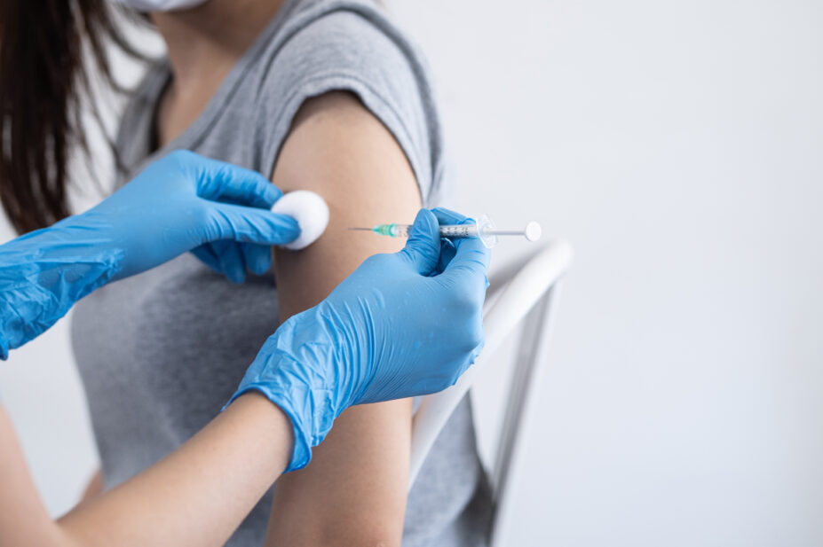 Healthcare professional injects flu vaccine into patient's arm