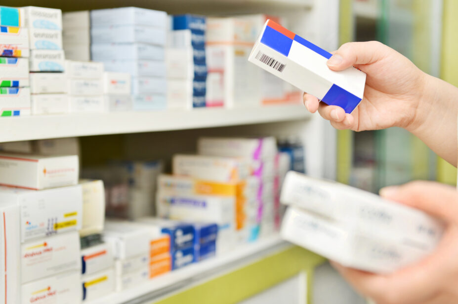 Pharmacist holding boxes of medicines