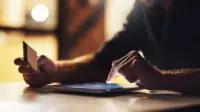 Man on tablet at home holding a credit card, suggesting online shopping concept