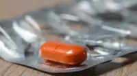 An image of one tablet remaining in a box of medicines