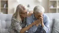 Photo of loving empathetic mature wife consoling depressed elder husband