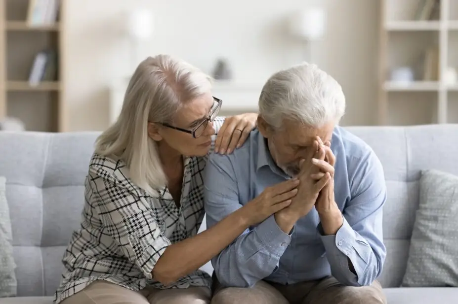 Photo of loving empathetic mature wife consoling depressed elder husband