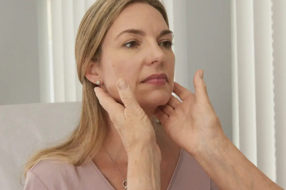 A healthcare professional checking a patient's lymph nodes