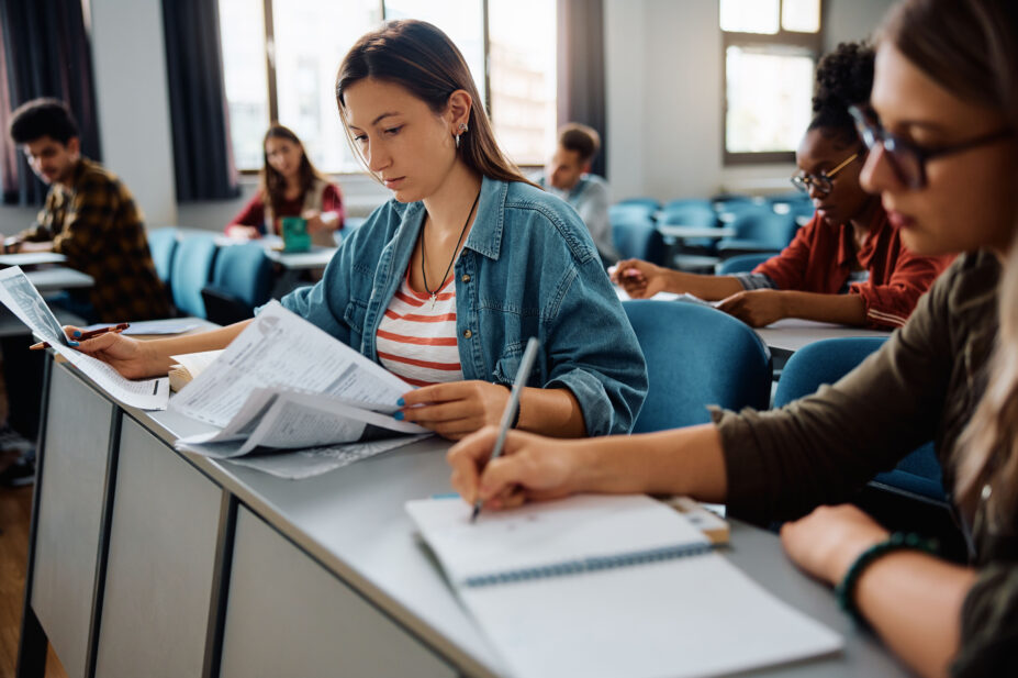 University sudents take notes during class