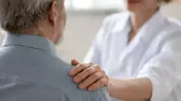 A healthcare professional consulting with a patient