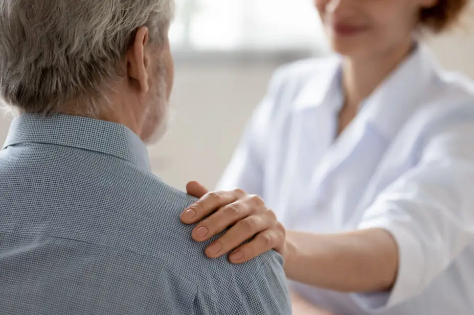 A healthcare professional consulting with a patient