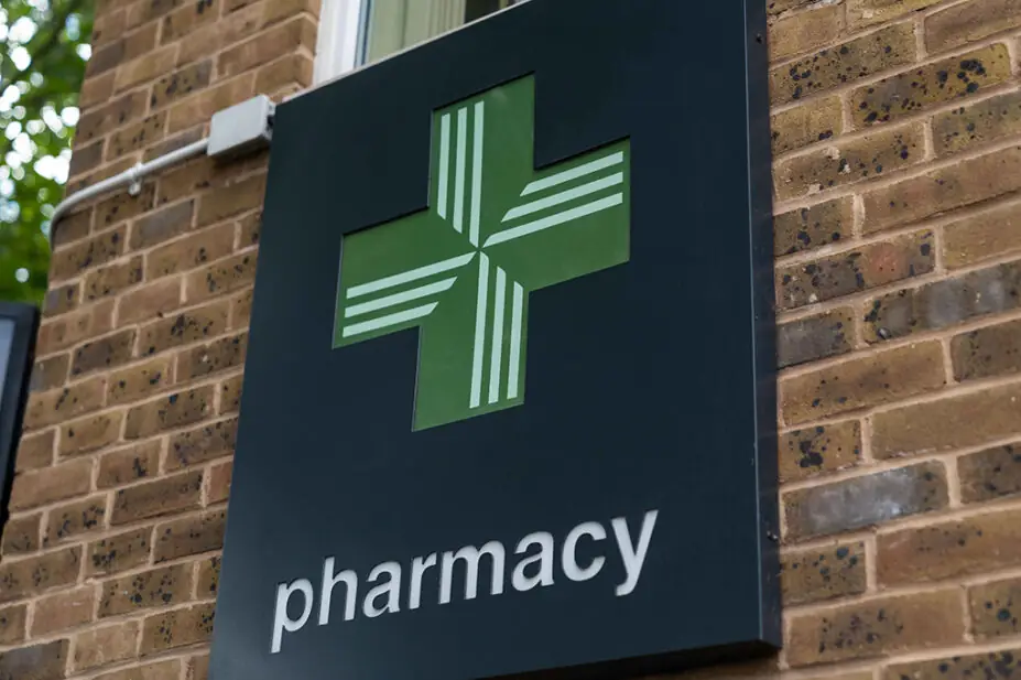 Pharmacy cross signage outside a Boots pharmacy