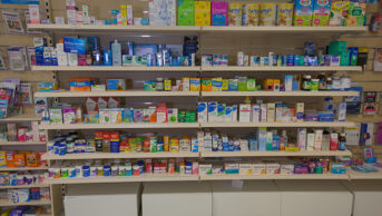 Pharmacy shelves in UK pharmacy