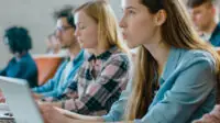 Students listen to a university lecture