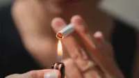 A smoker lights a cigarette