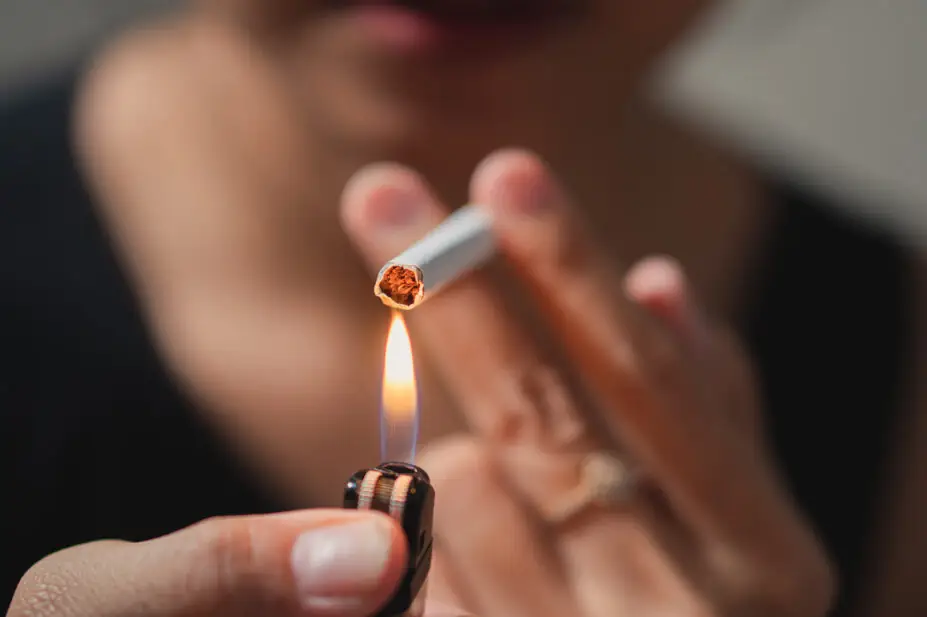 A smoker lights a cigarette