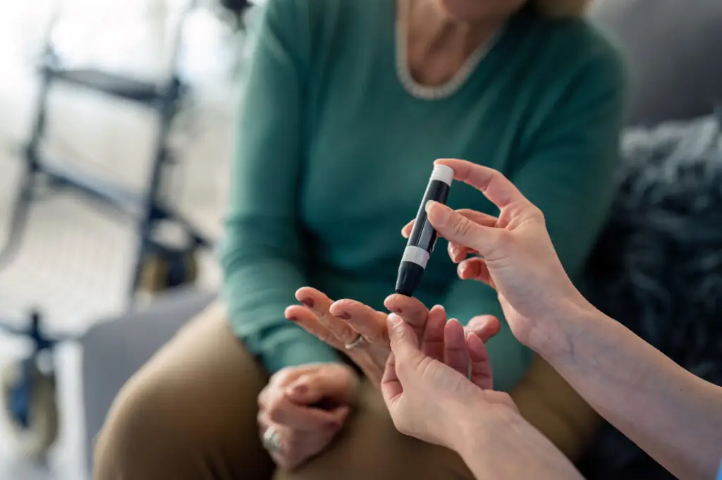 A woman having her blood sugar levels checked