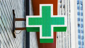 Pharmacy cross on side of building