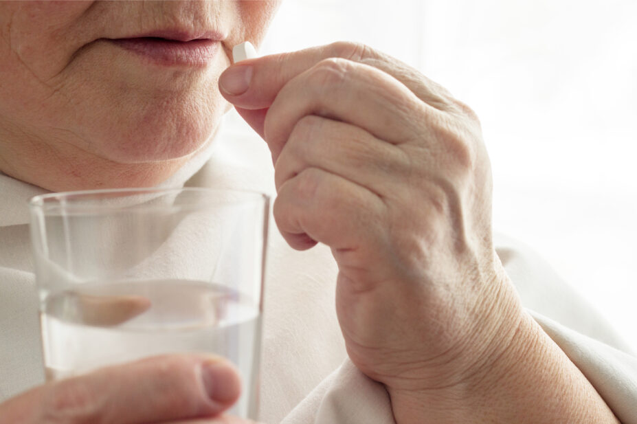 A woman takes a direct oral anticoagulant pill