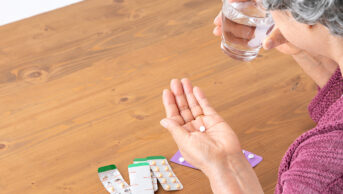 Older woman taking medicines