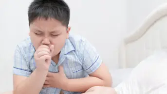 A photo of a child coughing