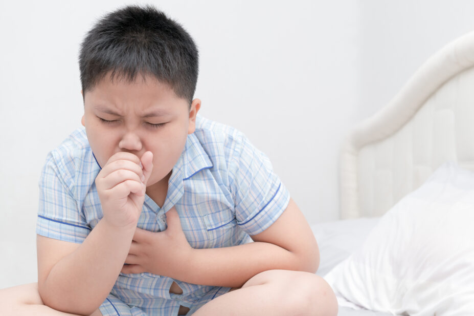 A photo of a child coughing