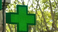 A pharmacy sign out side of a community pharmacy