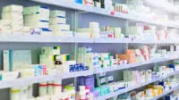 A shelf of medicines in a pharmacy