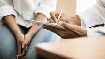 Healthcare professional consults with a patient