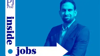 Sanjay Gudimetla stands with his arms crossed with a blue background