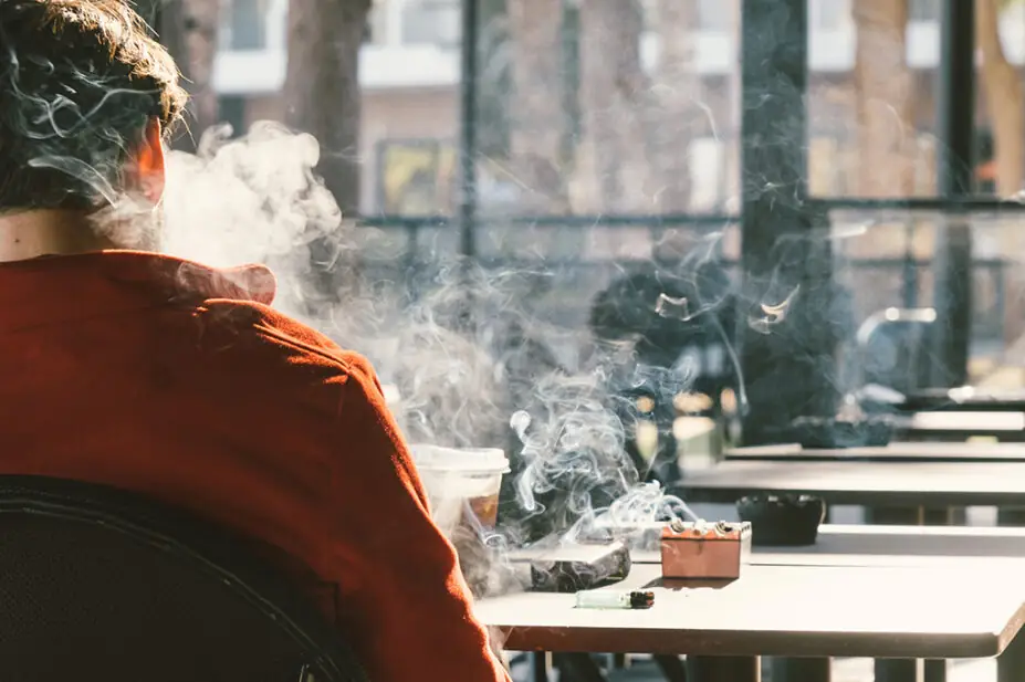Rear view of man smoking cigarette
