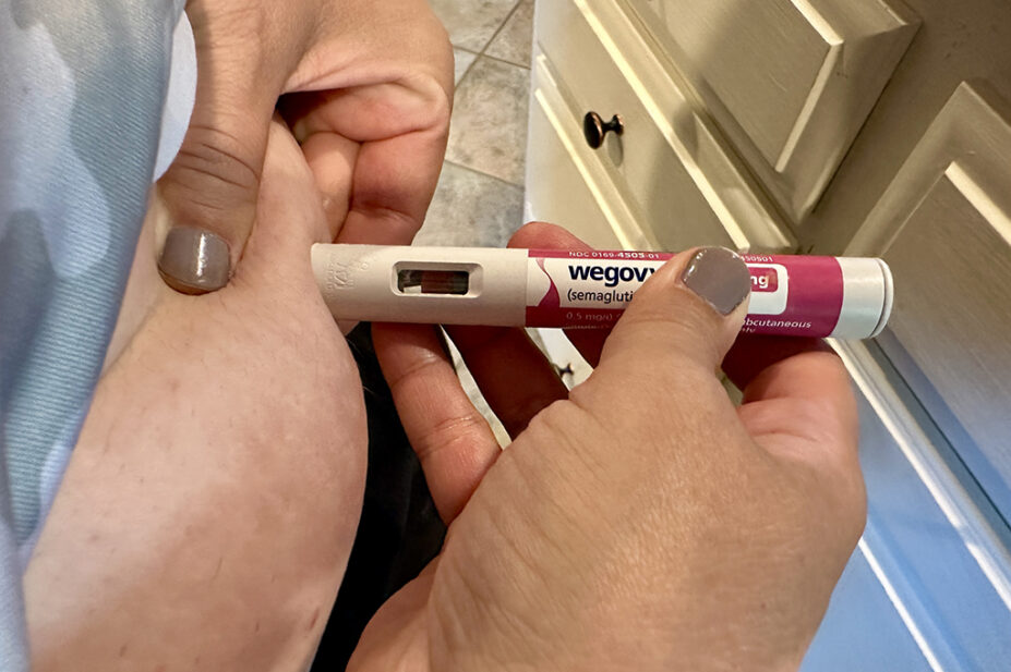 Someone injecting themselves with Wegovy pen