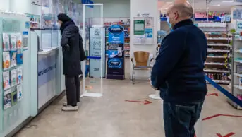 Customers waiting at pharmacy counter
