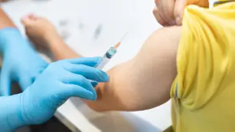 A person receives a measles vaccination