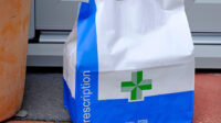 NHS prescription bag on someone's doorstep