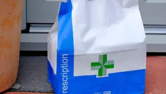 NHS prescription bag on someone's doorstep
