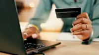 Laptop, credit card and woman hands for business transaction