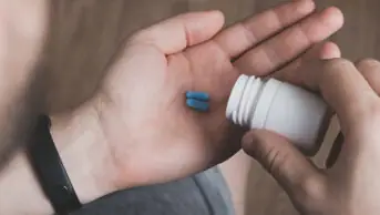 A man preparing to take PrEP pills for HIV prevention