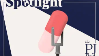 Microphone that looks like a tablet with spotlight written above, with light shining on it