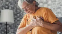 An older woman experiencing chest pains