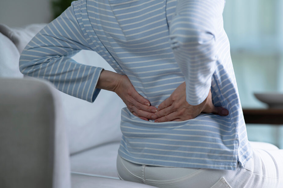 An older woman experiencing lower back pain