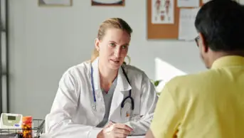 A GP consults with a patient