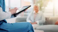 A healthcare professional looks up a patients digital care record