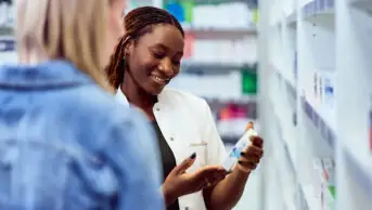 A pharmacist recommends medicine to a patient
