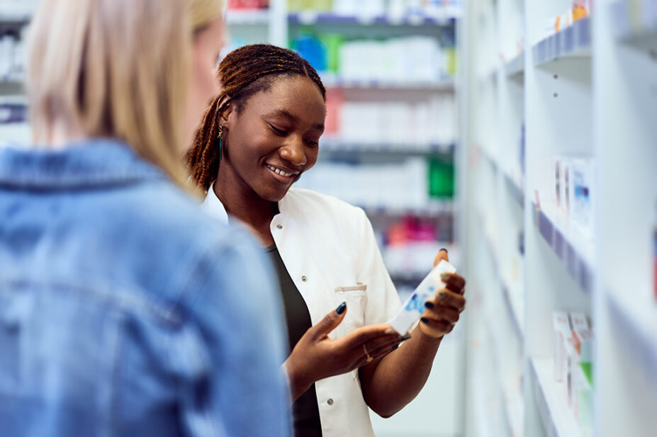 A pharmacist recommends medicine to a patient