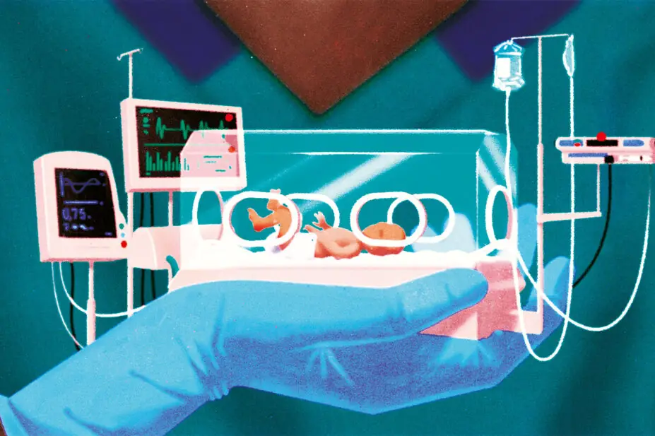 A pharmacist holds a baby in intensive care