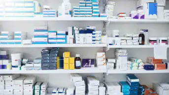 Pharmacy shelves with medicine packets on them