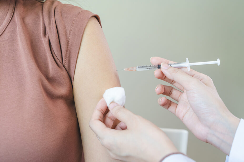 A healthcare professional administers a COVID-19 vaccination to a patient