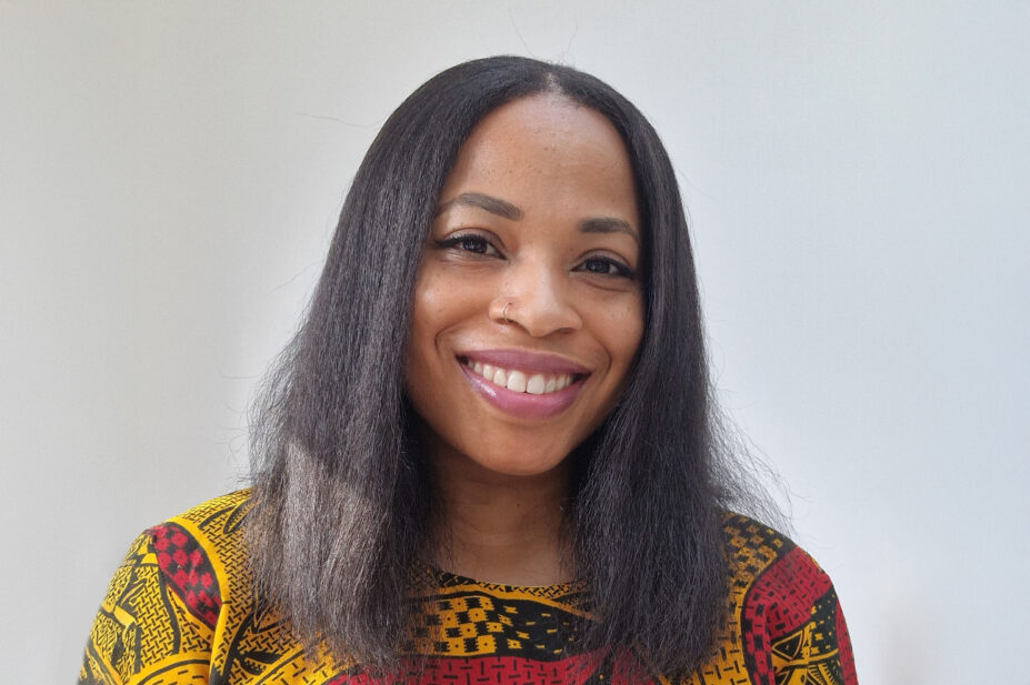 Ngozi Kalu smiles with a grey background